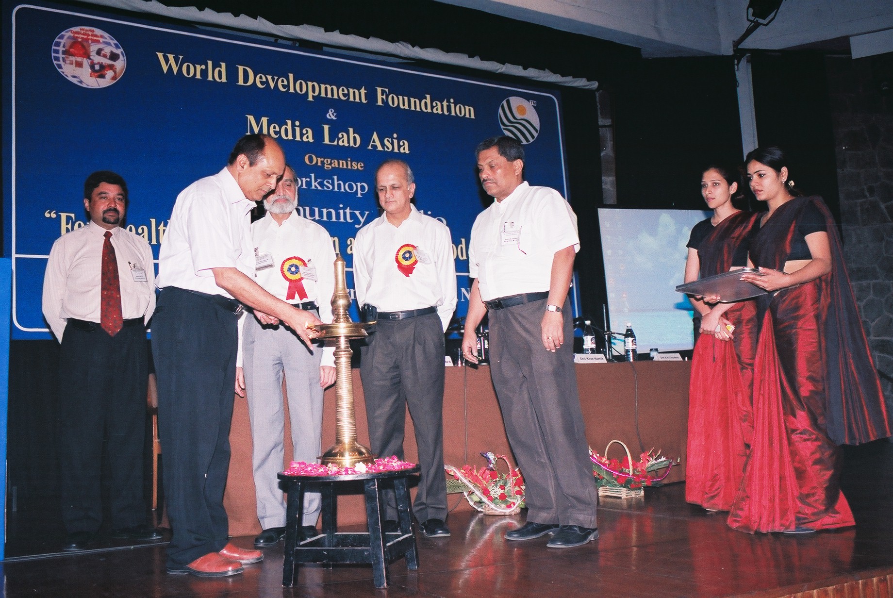 Dr. H. O. Srivastava lighting inaugural lamp in a Workshop.